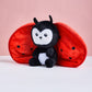 Plush toy with ladybug design on a pink background