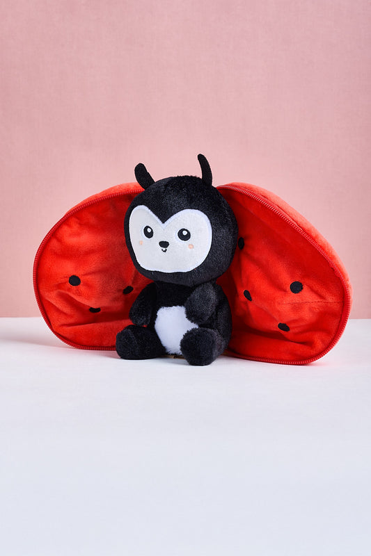 Plush toy with ladybug design on a pink background